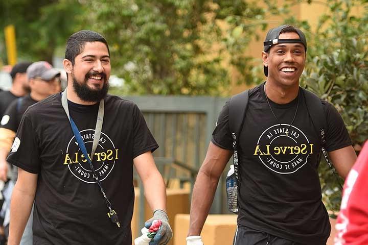 Two male students walking with I Serve L.A. t-shirts